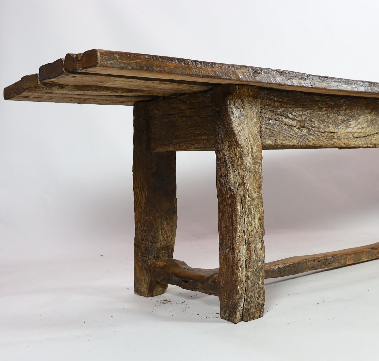 A rustic oak four plank top refectory table, length 320cm, width 78cm, height 78.5cm